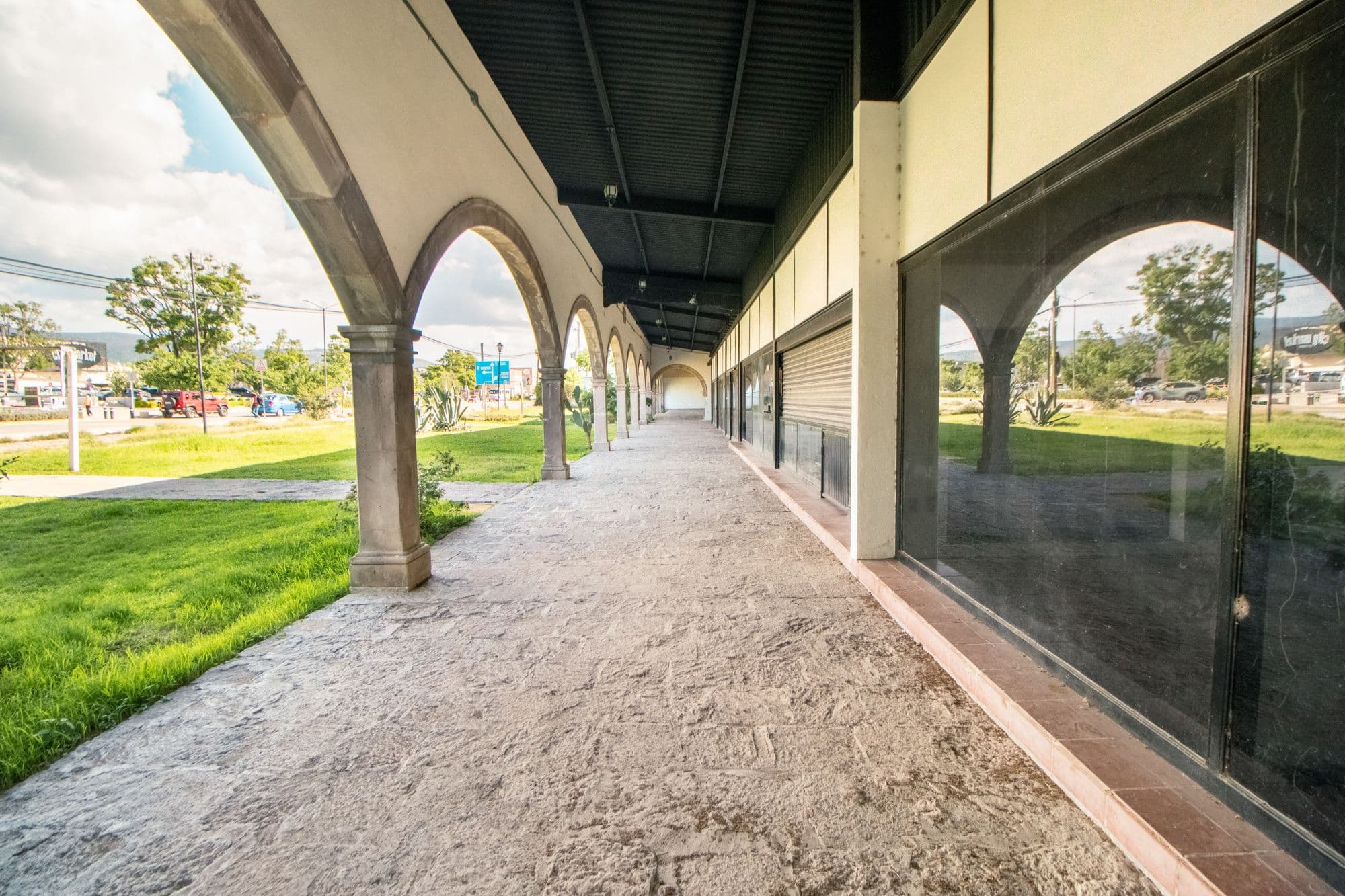 El Prado — Centro, San Miguel de Allende — photo 13 — elegant arched colonnade, verdant grounds