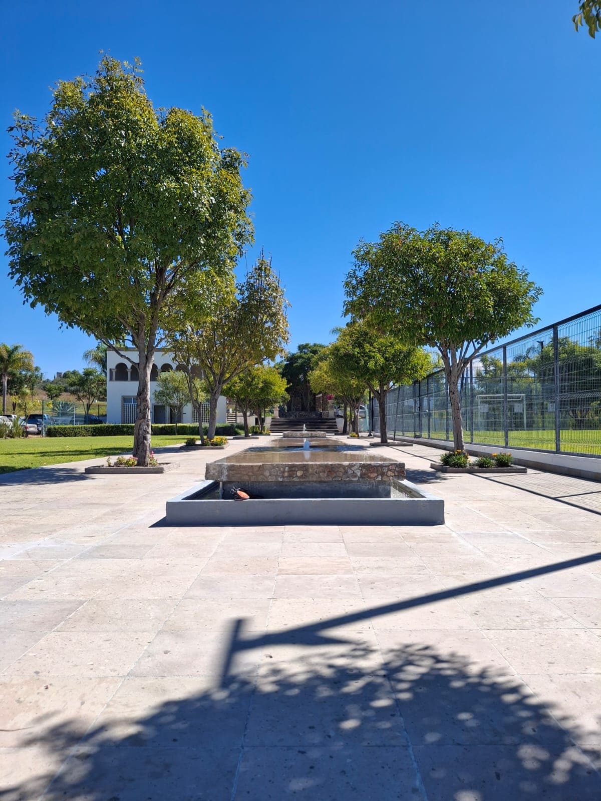Manzana 7 Lote 46 — Las Campanas, San Miguel de Allende — photo 6 — serene plaza with mature shade trees