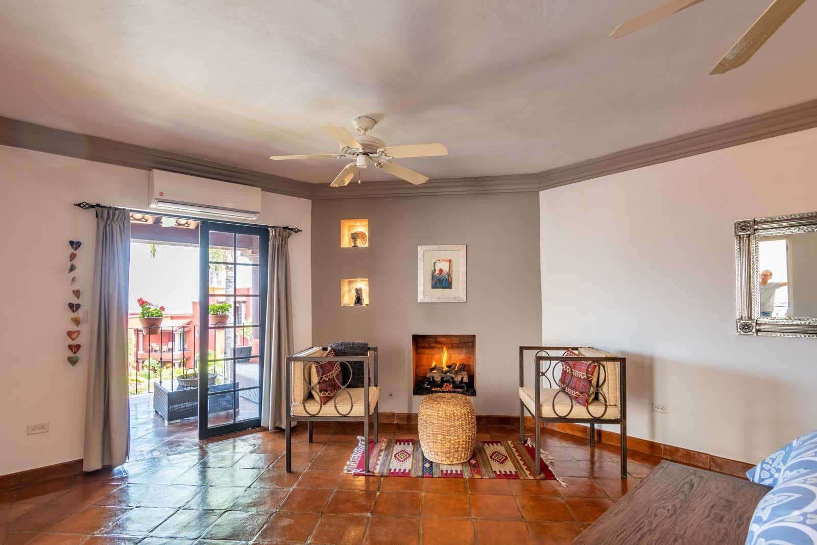 Casa Suerte — Balcones, San Miguel de Allende — photo 13 — luminous living room, fireplace warmth, terracotta charm