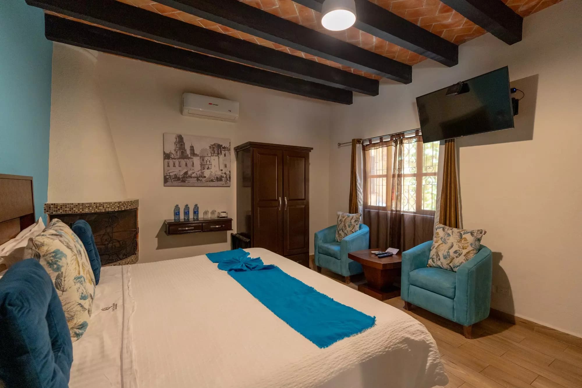 Hotel Centro — Centro, San Miguel de Allende — photo 2 — spacious master suite, rustic beams, turquoise accents