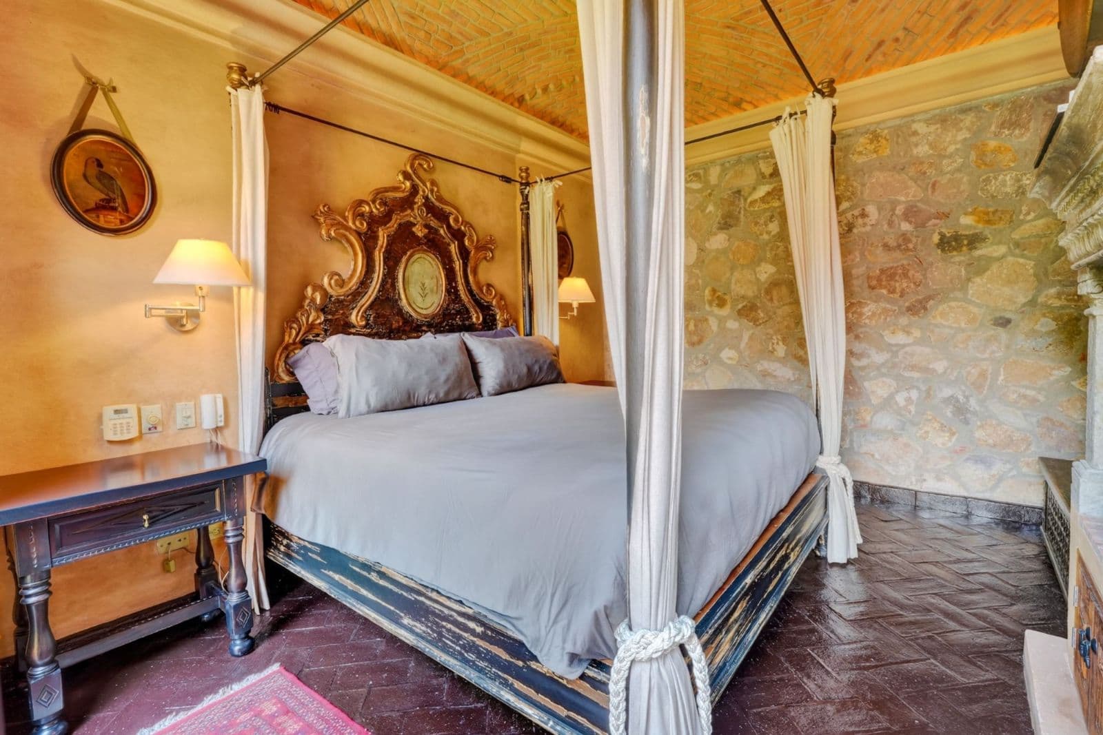 Villa Escondida — Centro, San Miguel de Allende — photo 20 — ornate four-poster bed, golden elegance