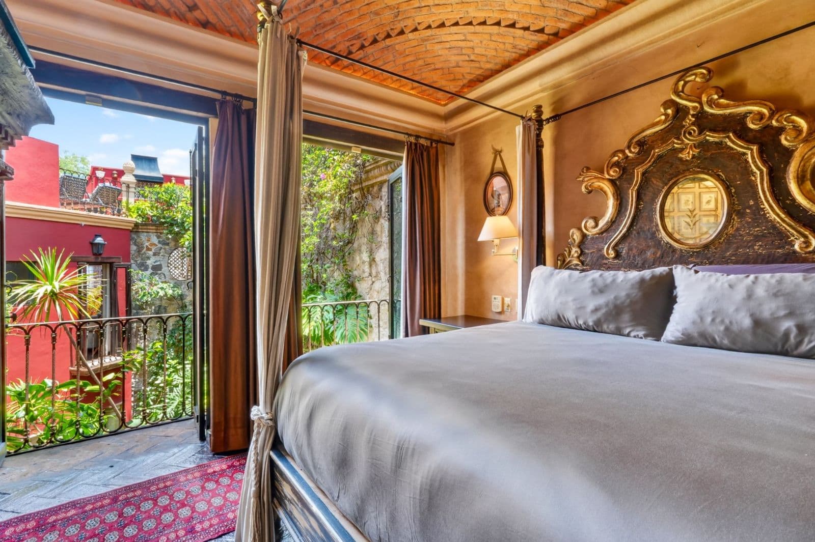 Villa Escondida — Centro, San Miguel de Allende — photo 19 — ornate colonial bedroom, garden views