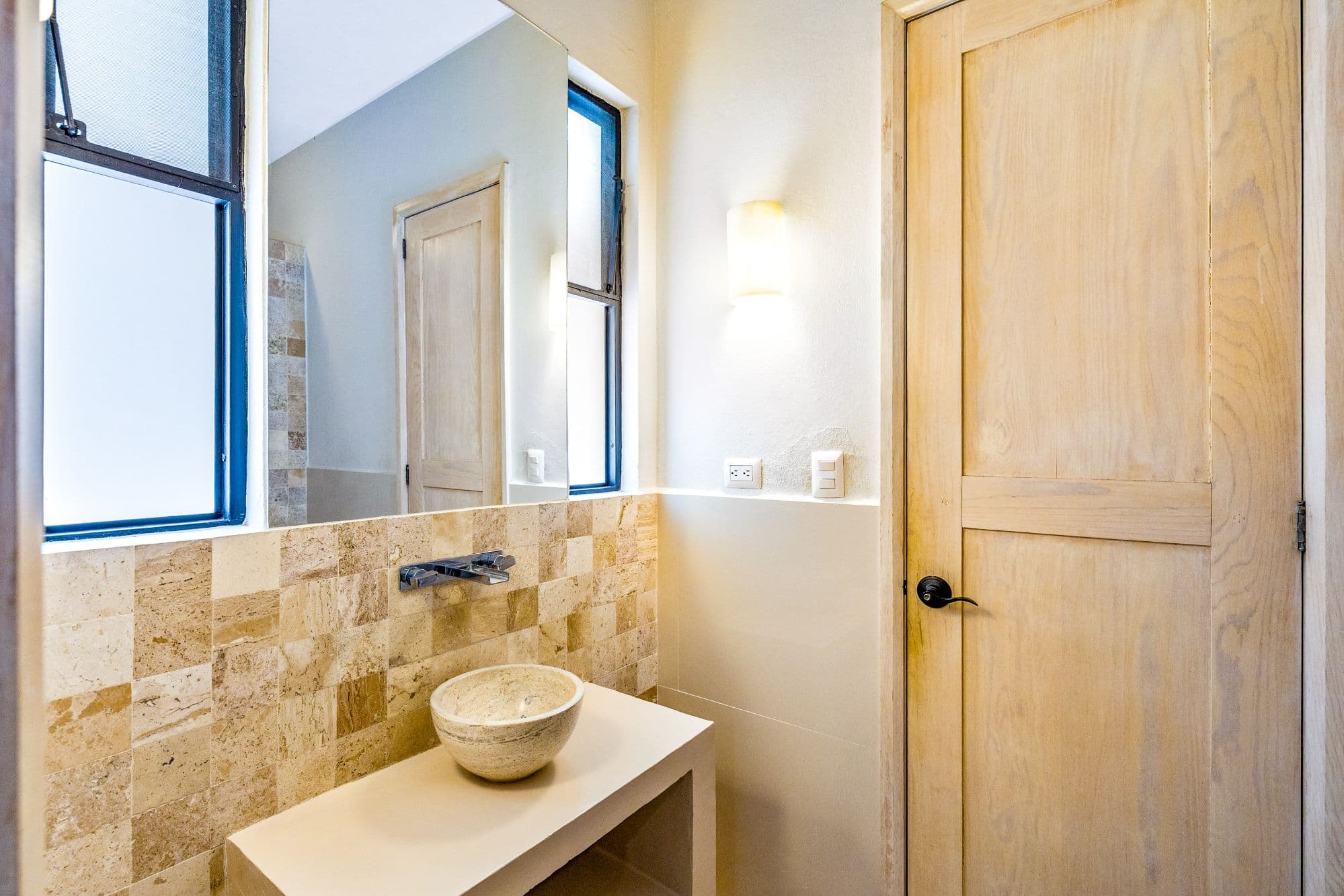 CASA PINO — Guadalupe, San Miguel de Allende — photo 12 — artisanal travertine bath, luminous elegance