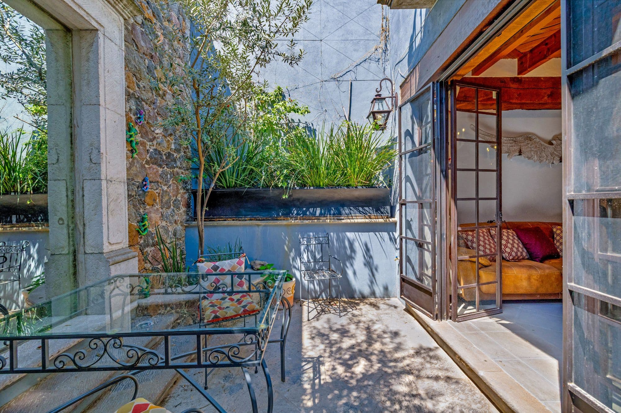 Casa Cocuchas — San Miguel de Allende Centro, San Miguel de Allende — photo 12 — waterfront terrace with dappled sunlight