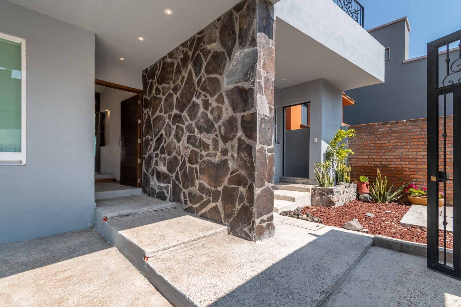 Casa Verona — El Capricho, San Miguel de Allende — photo 3 — stone entry courtyard, sophisticated modern design