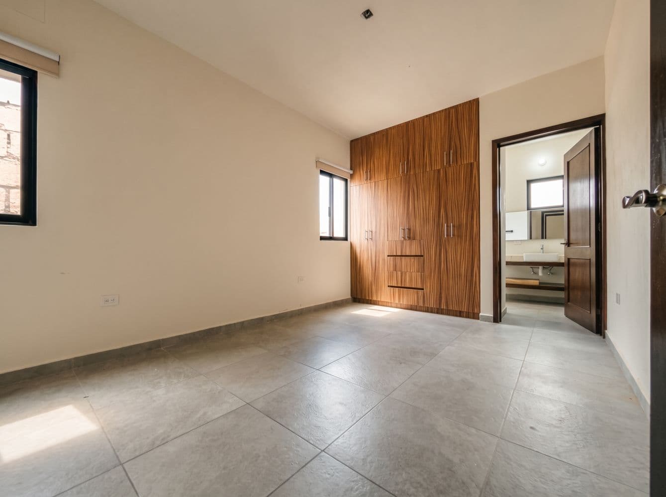 Casa Maple — Centro, San Miguel de Allende — photo 7 — sunlit bedroom with elegant wood cabinetry