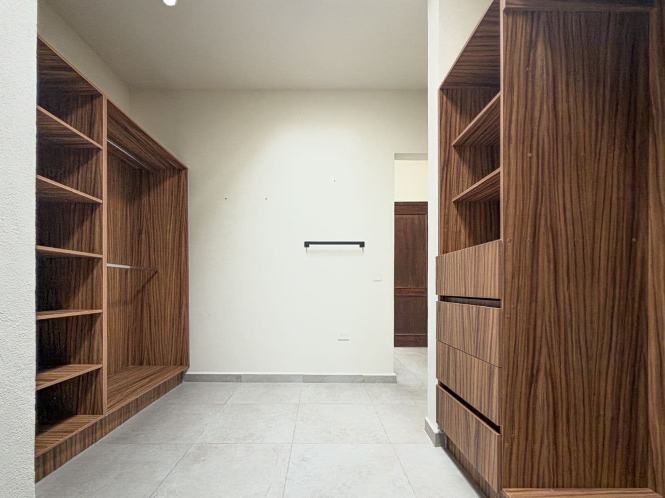 Casa Maple — Centro, San Miguel de Allende — photo 4 — sophisticated walk-in closet with rich wood cabinetry