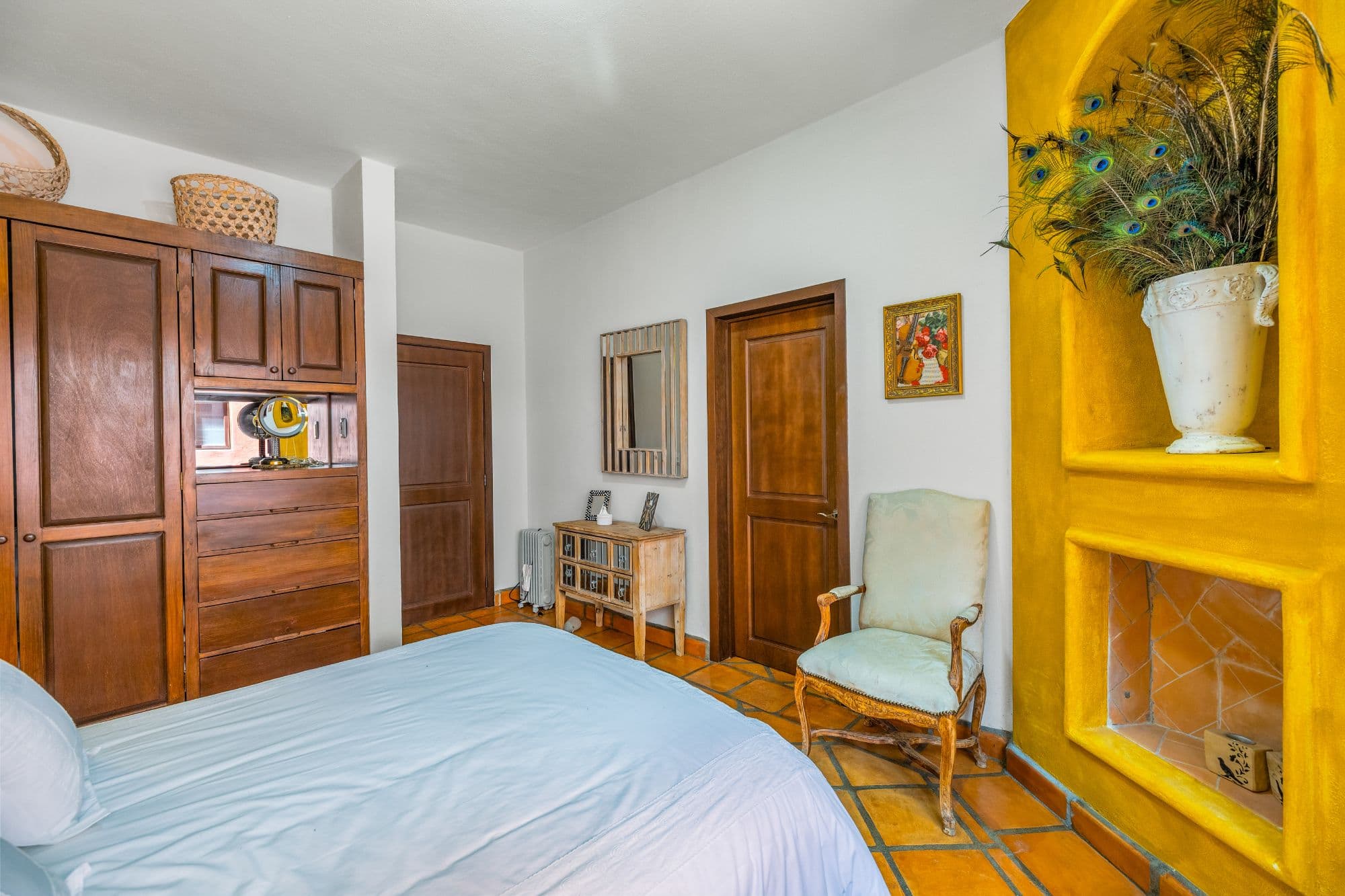 Condo Girasoles — San Miguel de Allende Centro, San Miguel de Allende — photo 15 — vibrant colonial bedroom with artistic character