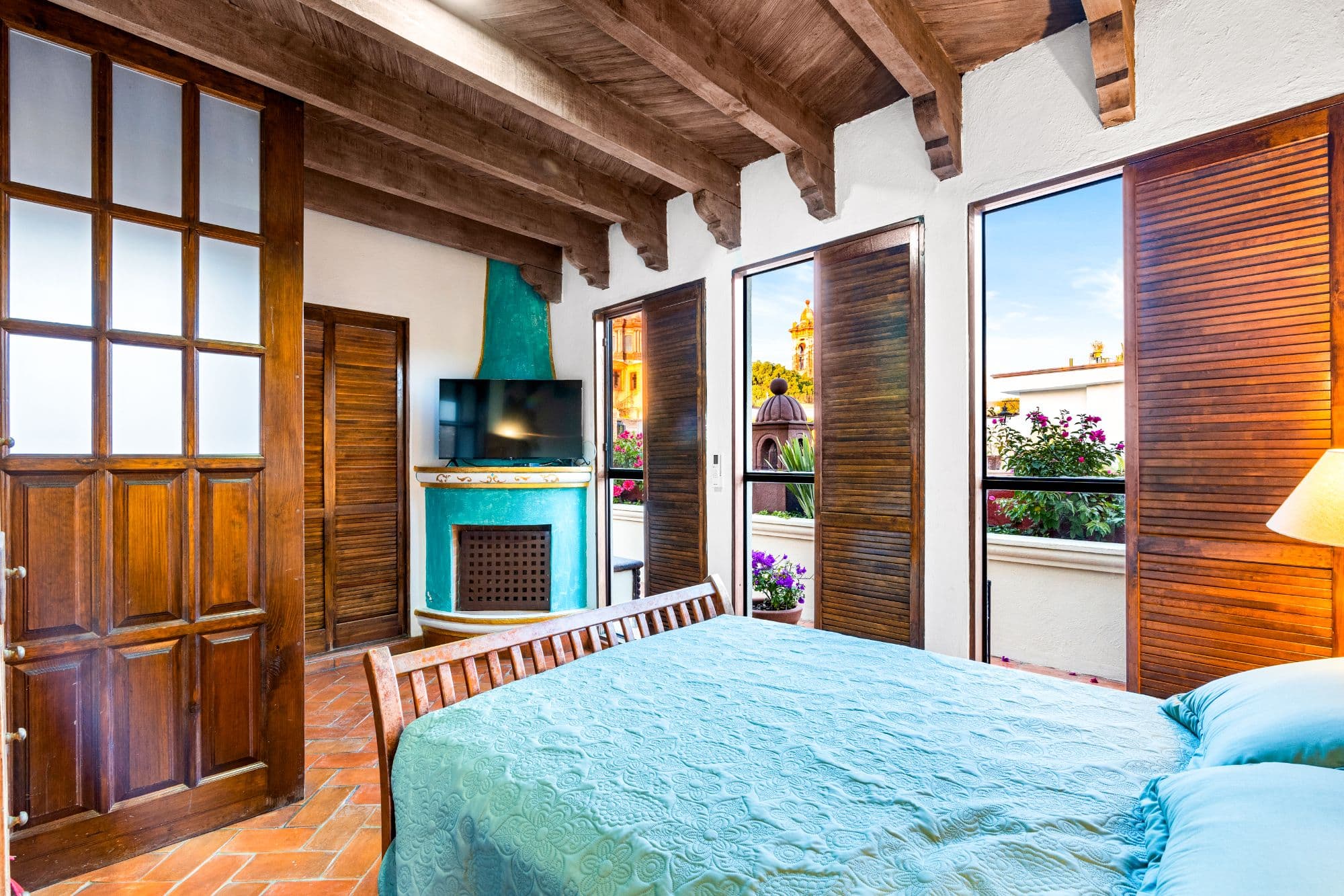 Casa Maria — San Miguel de Allende Centro, San Miguel de Allende — photo 25 — charming colonial bedroom, turquoise fireplace, cathedral views