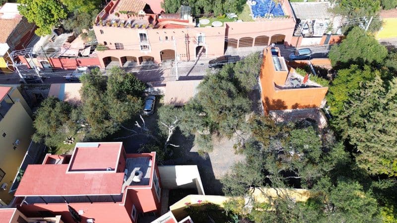 Salida a Qro Lot 147 — Centro, San Miguel de Allende — photo 3 — verdant gardens frame charming colonial architecture