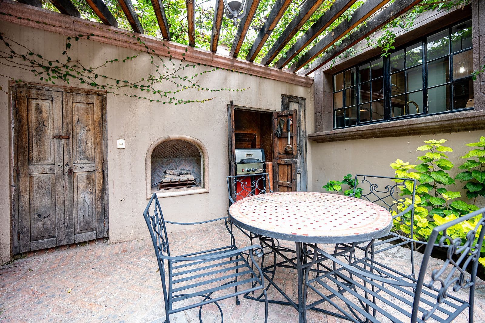 Casa Fia — Centro, San Miguel de Allende — photo 13 — charming courtyard with rustic fireplace