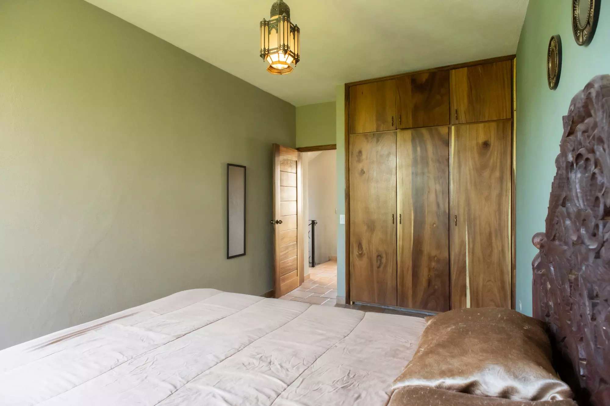 CASA LINDA — Lindavista, San Miguel de Allende — photo 9 — luminous bedroom with rustic wood wardrobes