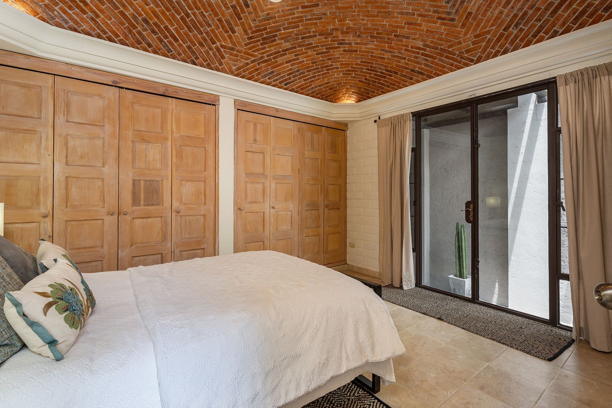Casa Esplendida — Ojo de Agua, San Miguel de Allende — photo 18 — serene master suite, architectural brick elegance