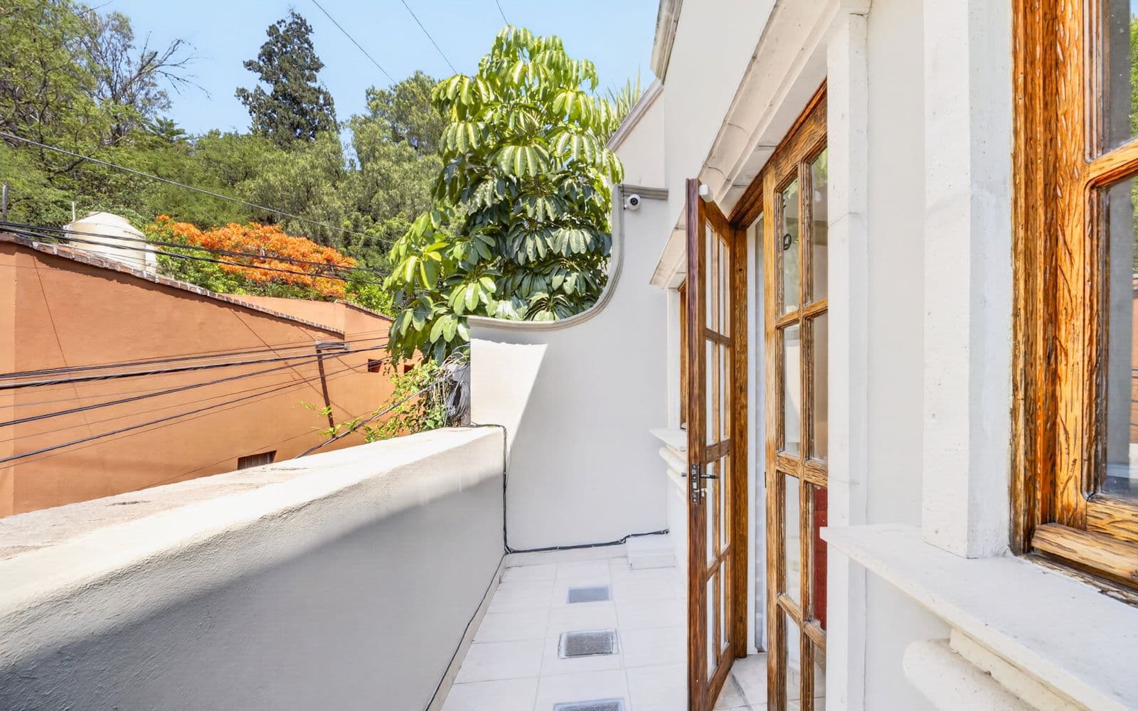 CASA PIEDRAS CHINAS — Centro, San Miguel de Allende — photo 12 — sunlit terrace with charming wooden doors