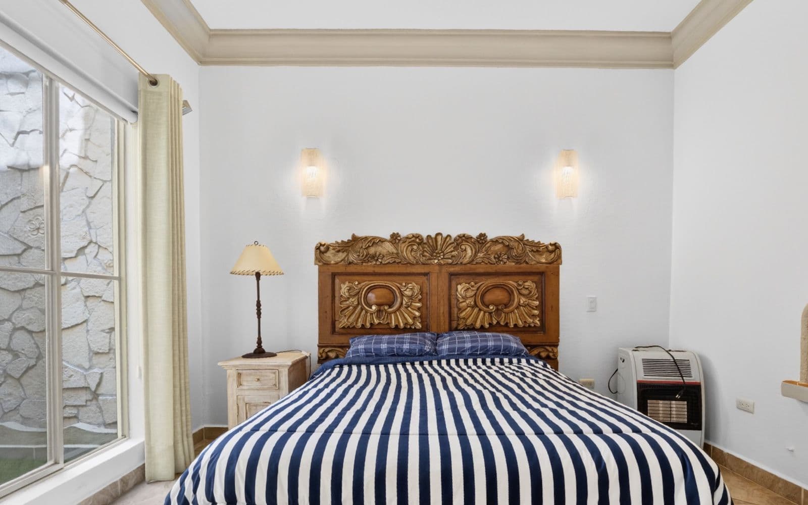 CASA PIEDRAS CHINAS — Centro, San Miguel de Allende — photo 8 — serene bedroom, sculptural carved headboard
