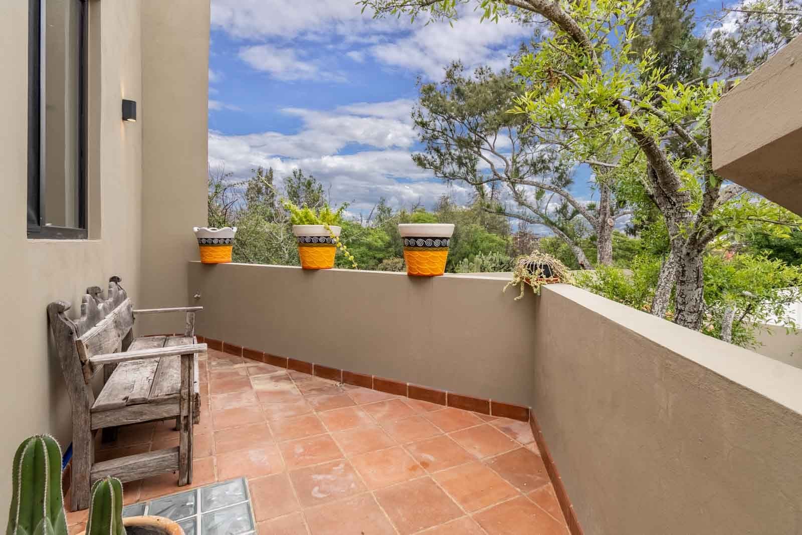 Casa Vista del Cielo — Atascadero (Arcos de San Miguel), San Miguel de Allende — photo 18 — serene terracotta terrace with panoramic mountain vistas