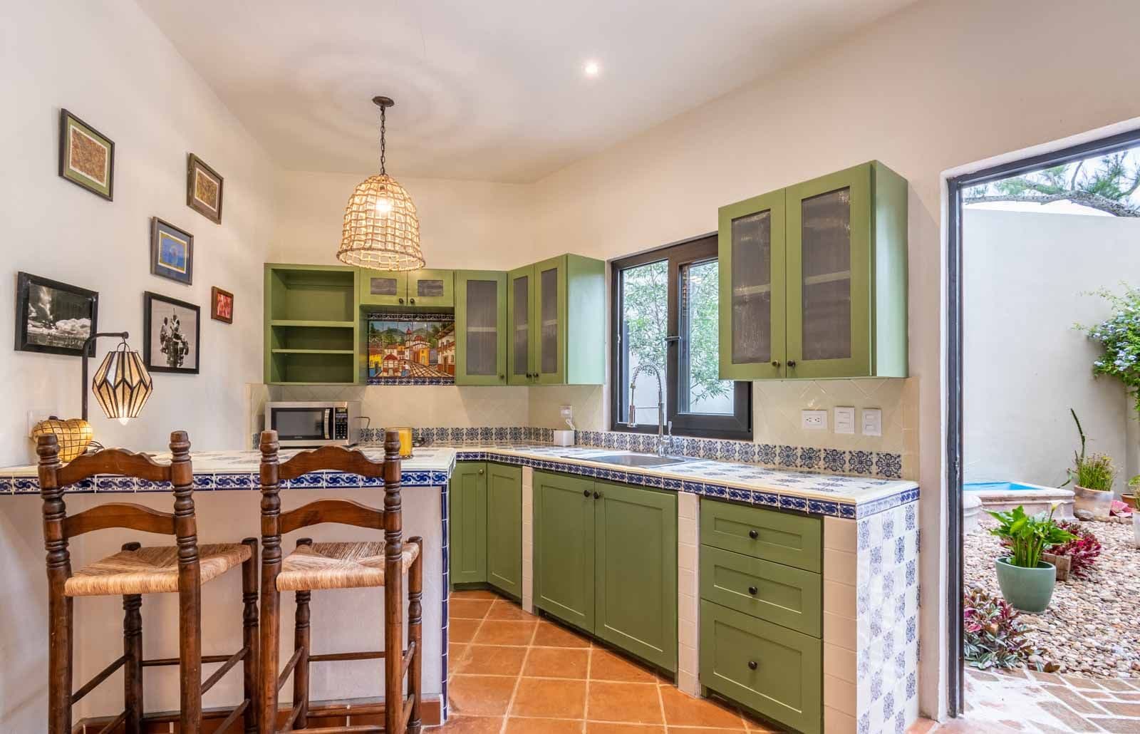 Casa Vista del Cielo — Atascadero (Arcos de San Miguel), San Miguel de Allende — photo 17 — charming traditional kitchen, vibrant green cabinetry