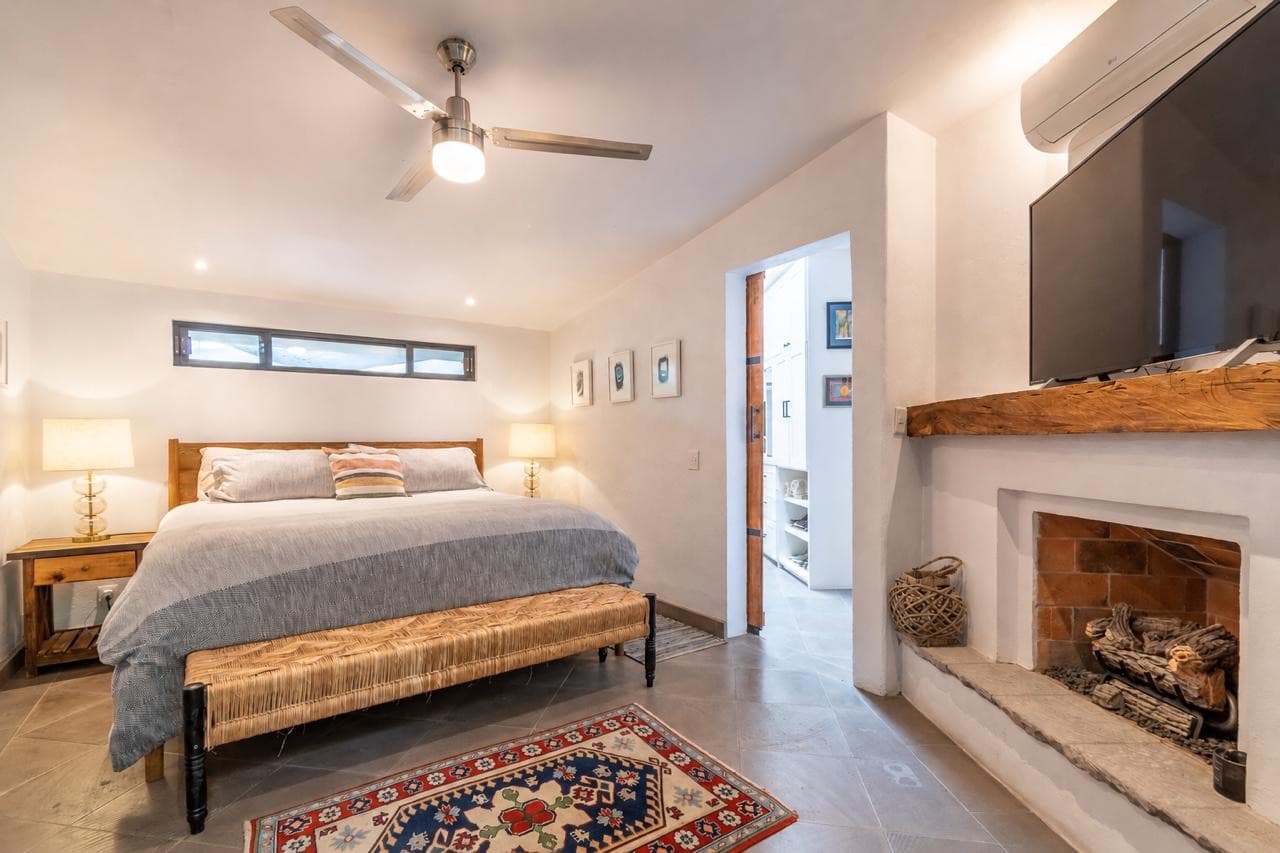 Casa Vista del Cielo — Atascadero (Arcos de San Miguel), San Miguel de Allende — photo 9 — serene master suite with rustic fireplace charm