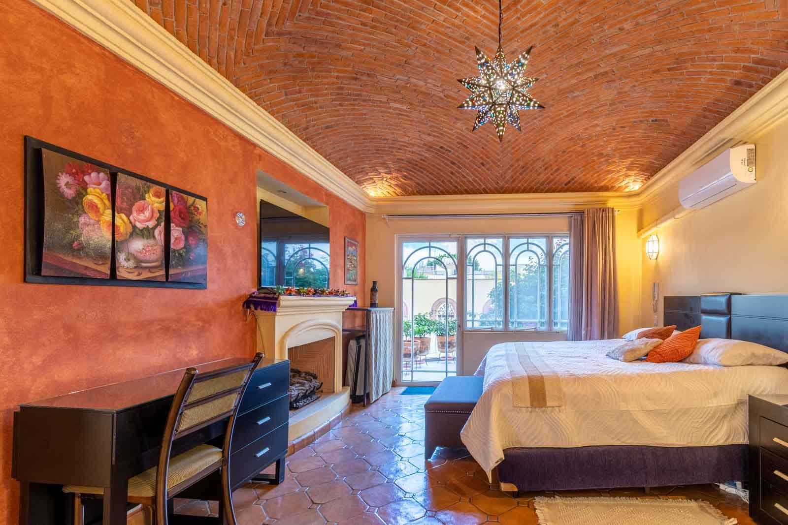 CASA ARCO de LUZ — Guadalupe, San Miguel de Allende — photo 16 — warm terracotta luxury bedroom retreat