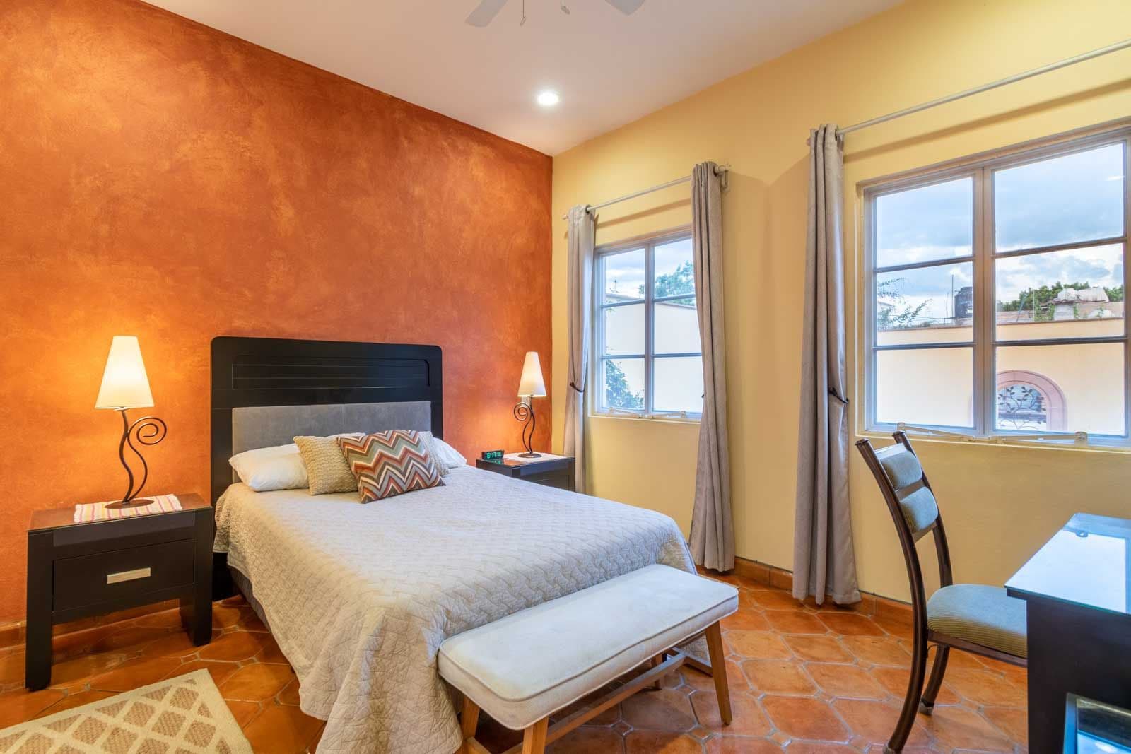 CASA ARCO de LUZ — Guadalupe, San Miguel de Allende — photo 14 — vibrant master suite, terracotta warmth, panoramic windows