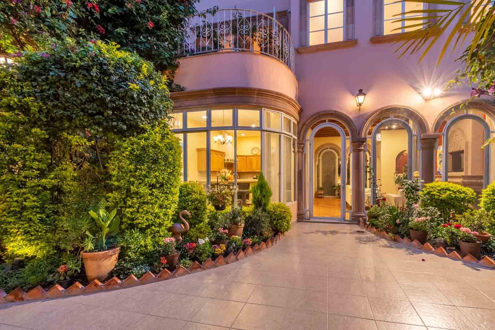 CASA ARCO de LUZ — Guadalupe, San Miguel de Allende — photo 2 — elegant courtyard with ambient evening lighting