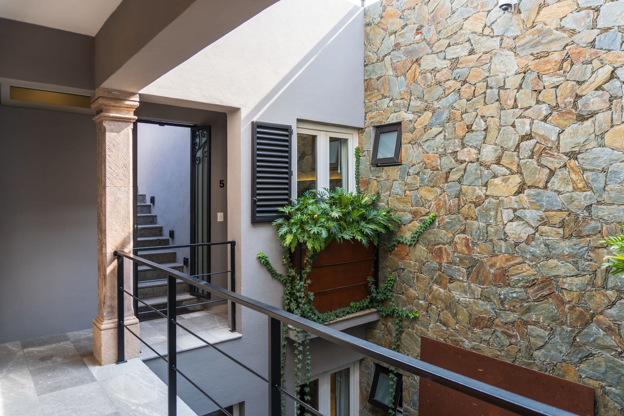 CASA XANTHE — Centro, San Miguel de Allende — photo 19 — sophisticated courtyard, rustic stone elegance