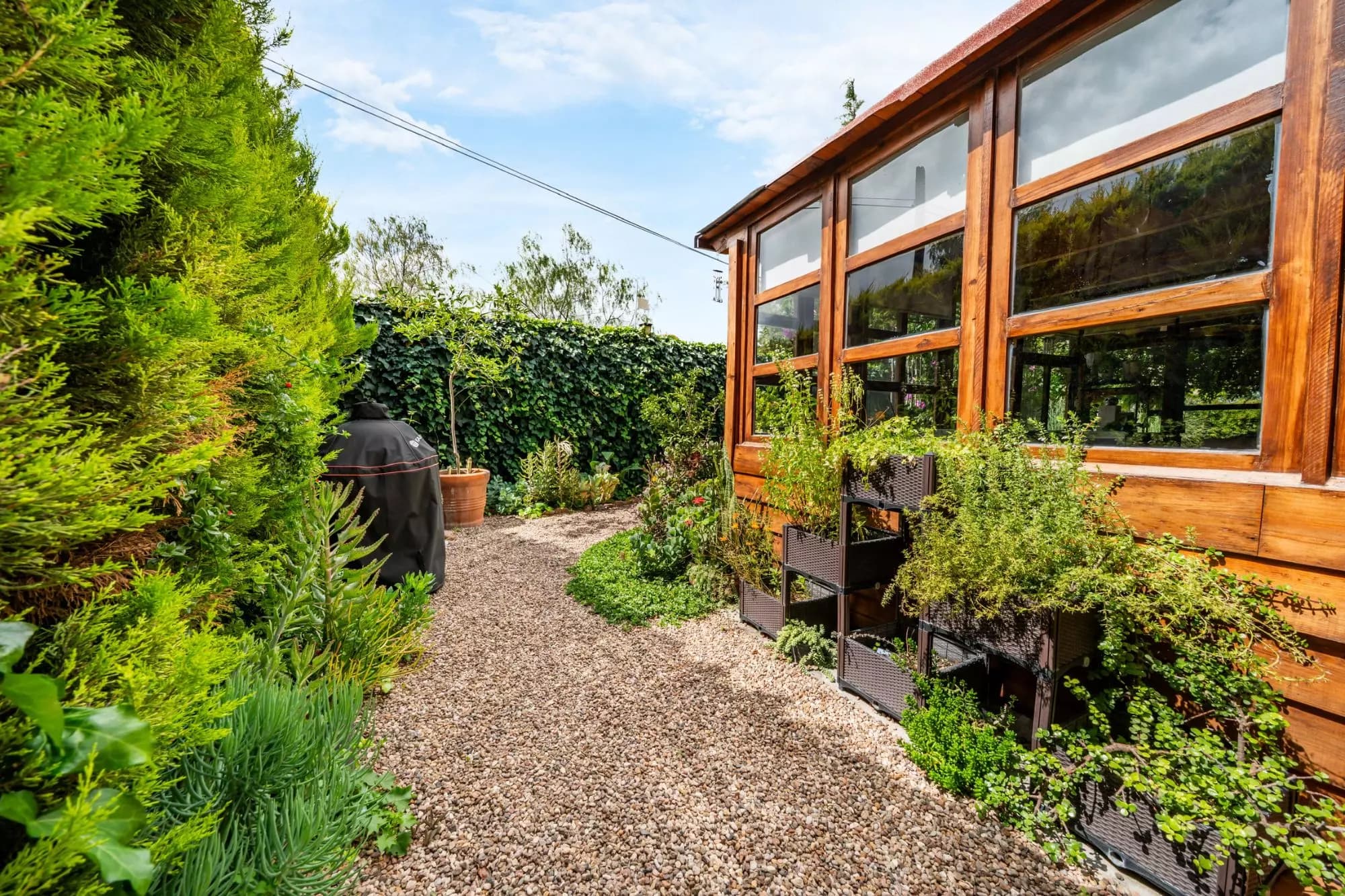 Casa Wabi Sabi en Rancho Labradores — Los Labradores, San Miguel de Allende — photo 12 — serene garden conservatory with mature landscaping