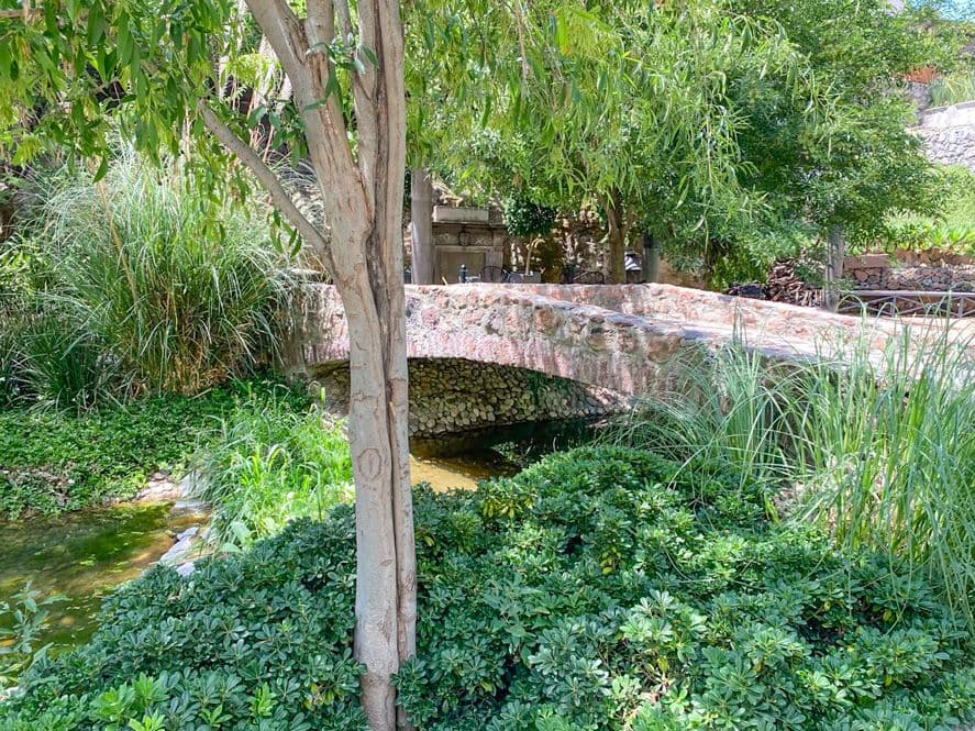 Casa Huerta La Antigua — Antigua Residencial, San Miguel de Allende — photo 6 — historic stone bridge, lush verdant gardens