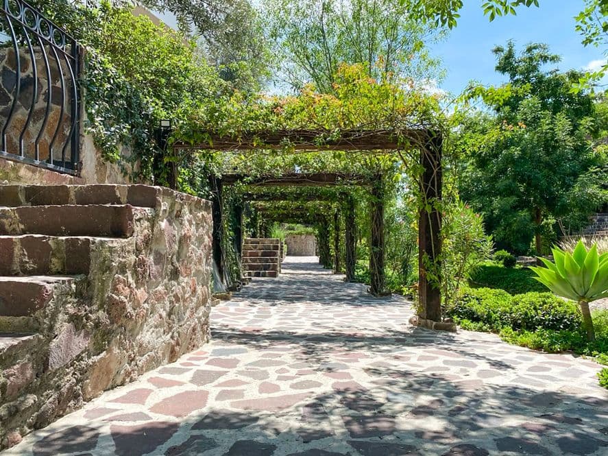 Casa Huerta La Antigua — Antigua Residencial, San Miguel de Allende — photo 7 — shaded pergola through lush gardens