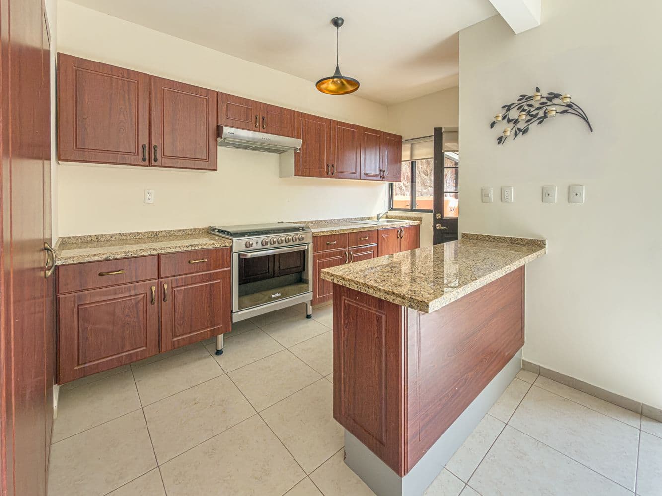 Casa Terracota — Zirándaro, San Miguel de Allende — photo 5 — sophisticated chef's kitchen, warm wood cabinetry