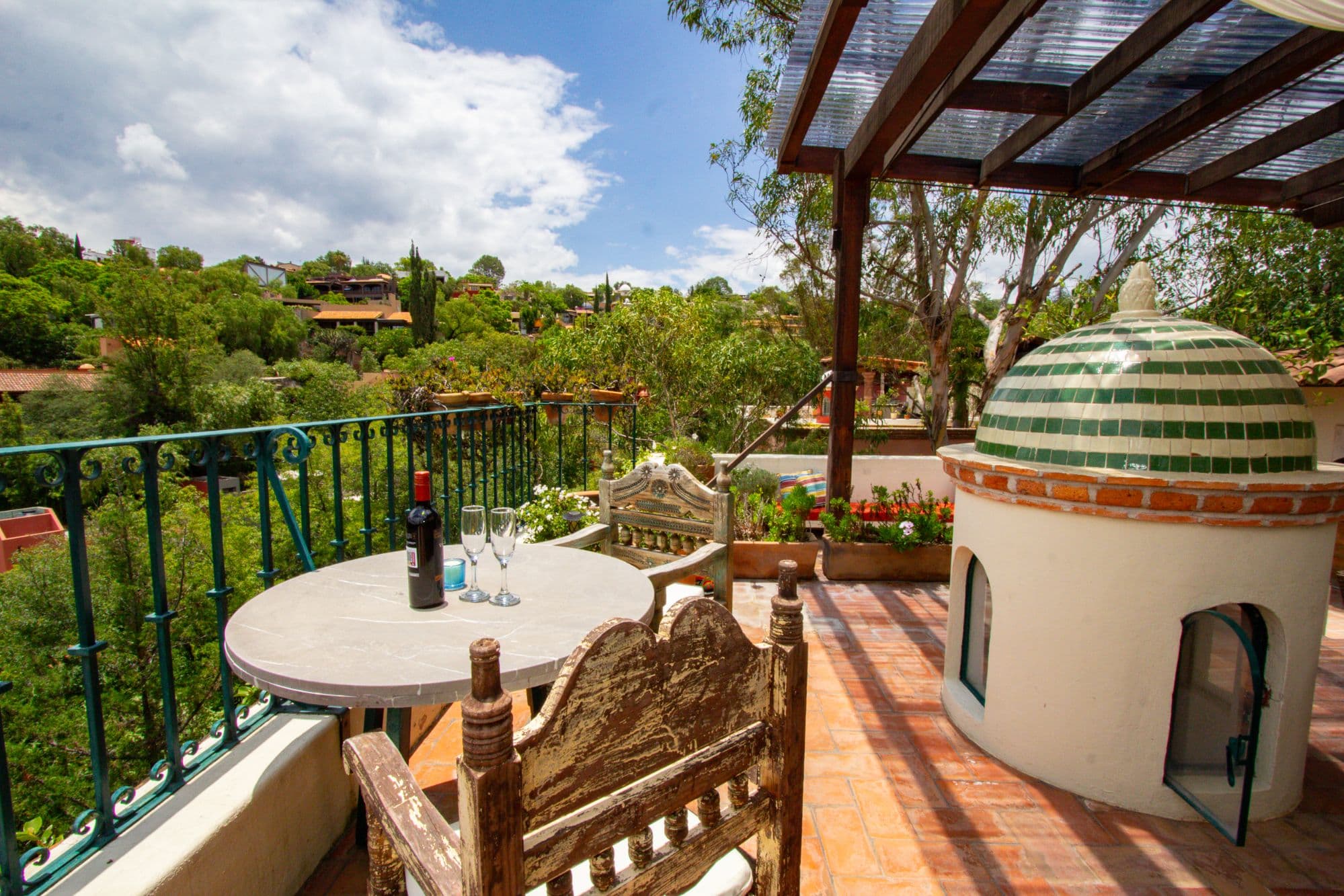Condo Sto. Domingo — Centro, San Miguel de Allende — photo 15 — terrace dining with verdant hillside views