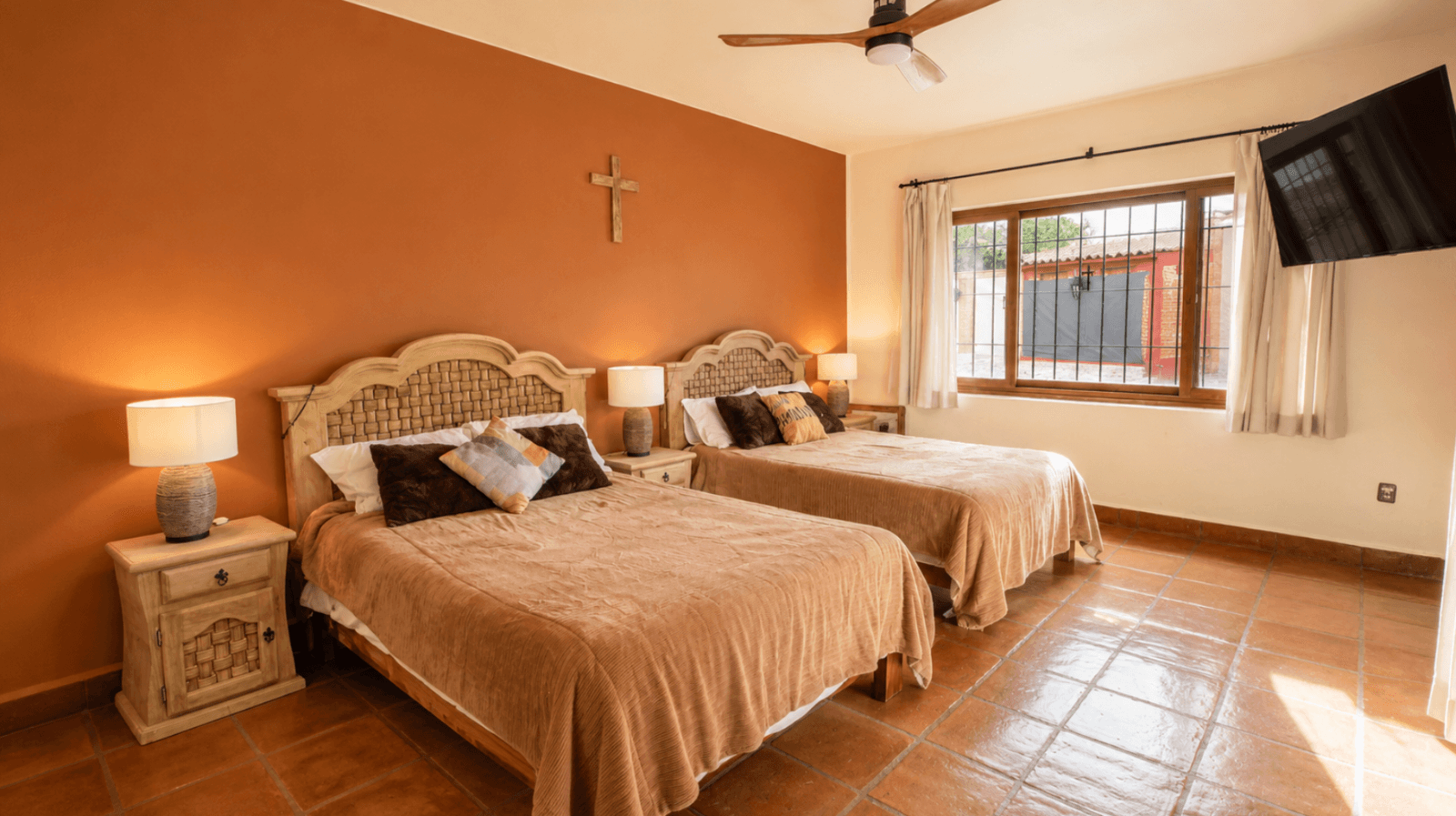 Casa Encantada — Sosnabar, San Miguel de Allende — photo 21 — serene dual bedroom with terracotta warmth