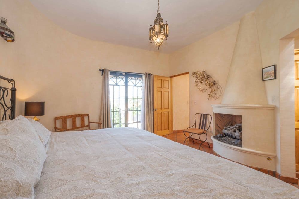 Casa Tranquila — San Antonio, San Miguel de Allende — photo 17 — luminous master suite, fireplace warmth