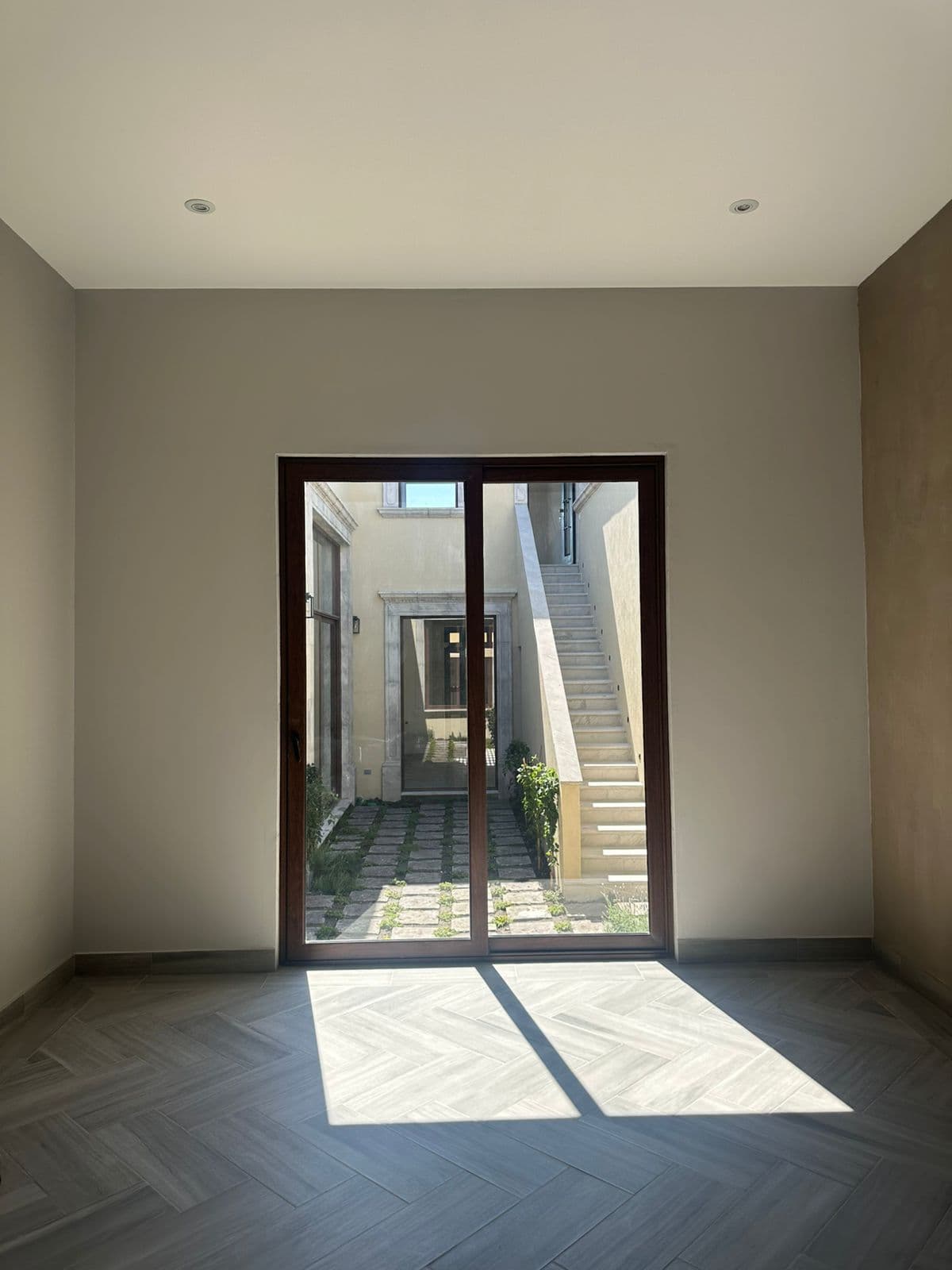 Casa Olivos — Residencial Malanquin la Mesa, San Miguel de Allende — photo 15 — sun-drenched courtyard with herringbone floors