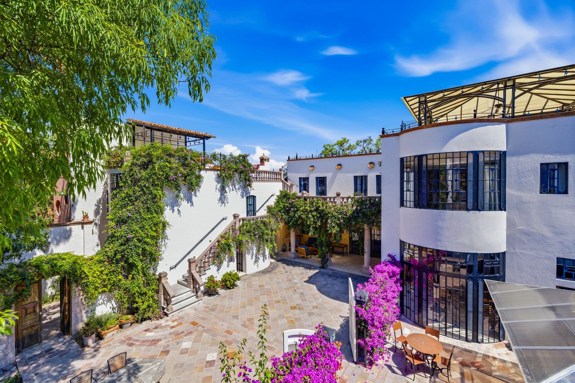 Casa Grande — Guadiana, San Miguel de Allende — photo 17 — charming colonial courtyard, vibrant bougainvillea accents