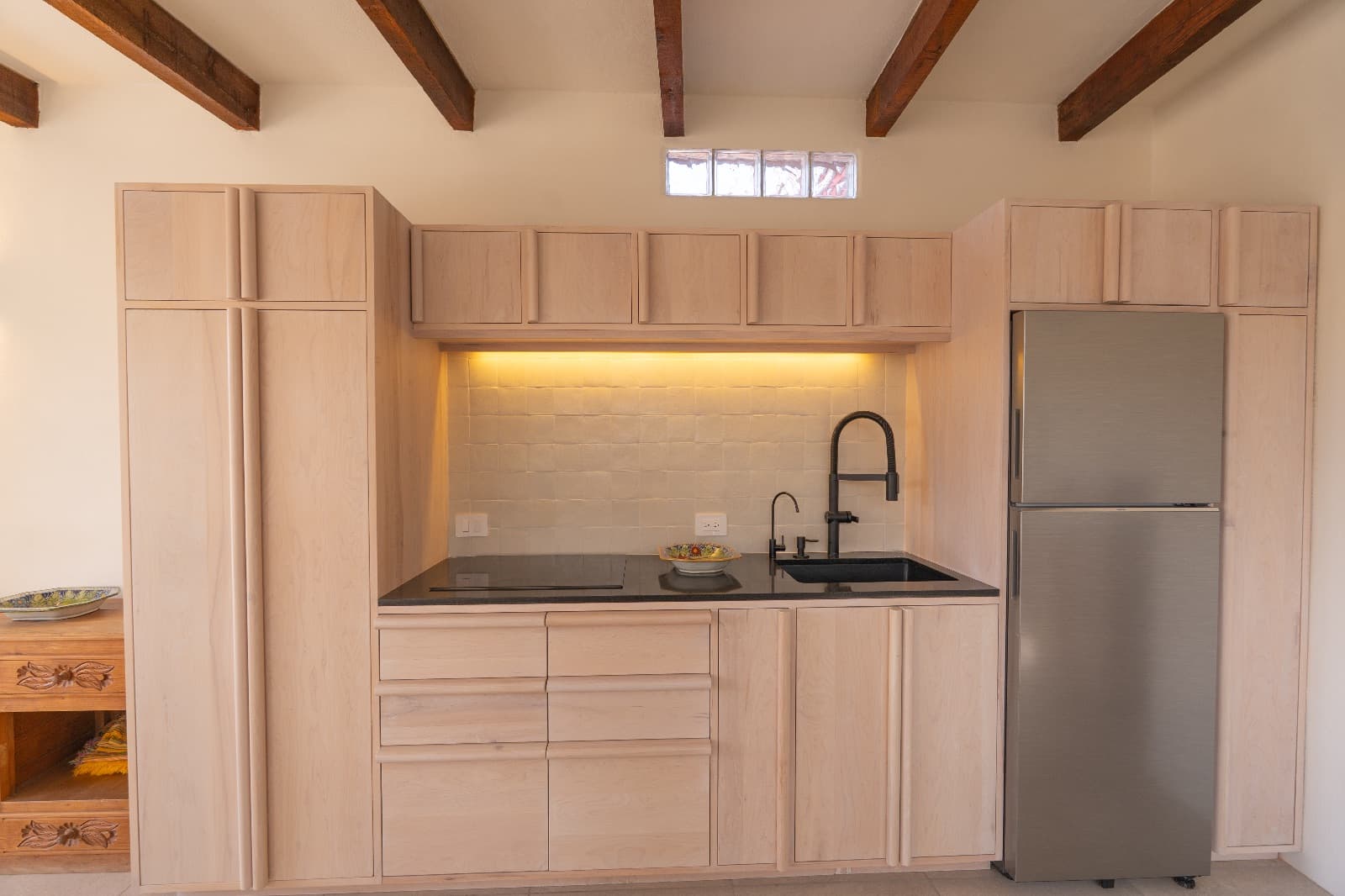 Condo del Sol — Guadalupe, San Miguel de Allende — photo 6 — refined minimalist kitchen, architectural beams