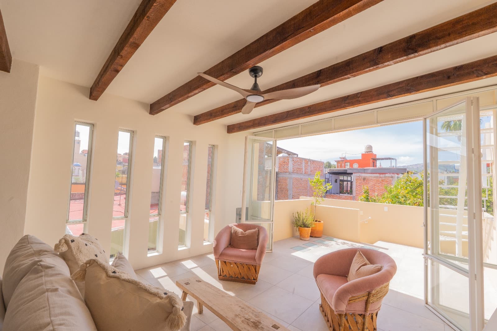Condo del Sol — Guadalupe, San Miguel de Allende — photo 10 — sunlit terrace with rustic beam charm