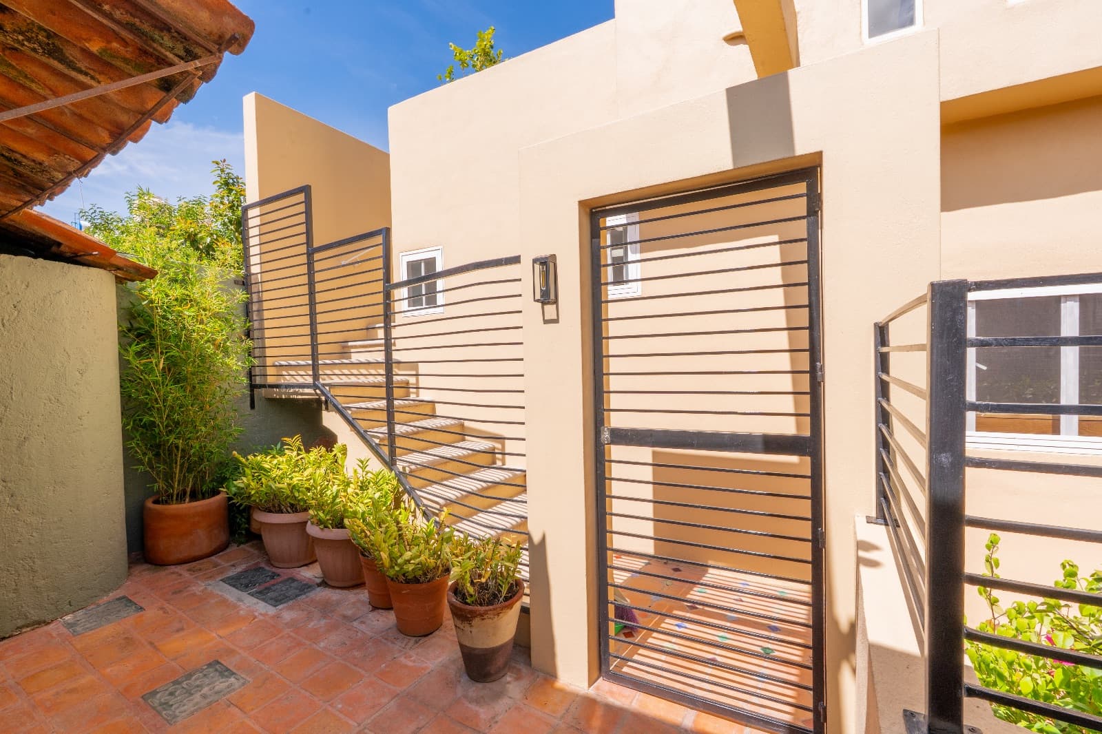 Condo del Sol — Guadalupe, San Miguel de Allende — photo 20 — sunlit courtyard with contemporary railing details