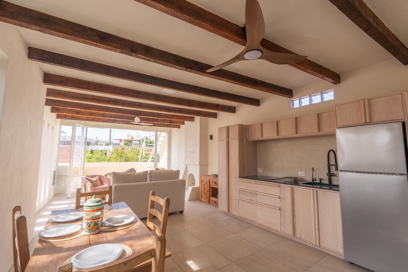 Condo del Sol — Guadalupe, San Miguel de Allende — photo 2 — sun-drenched open-concept living with rustic beams