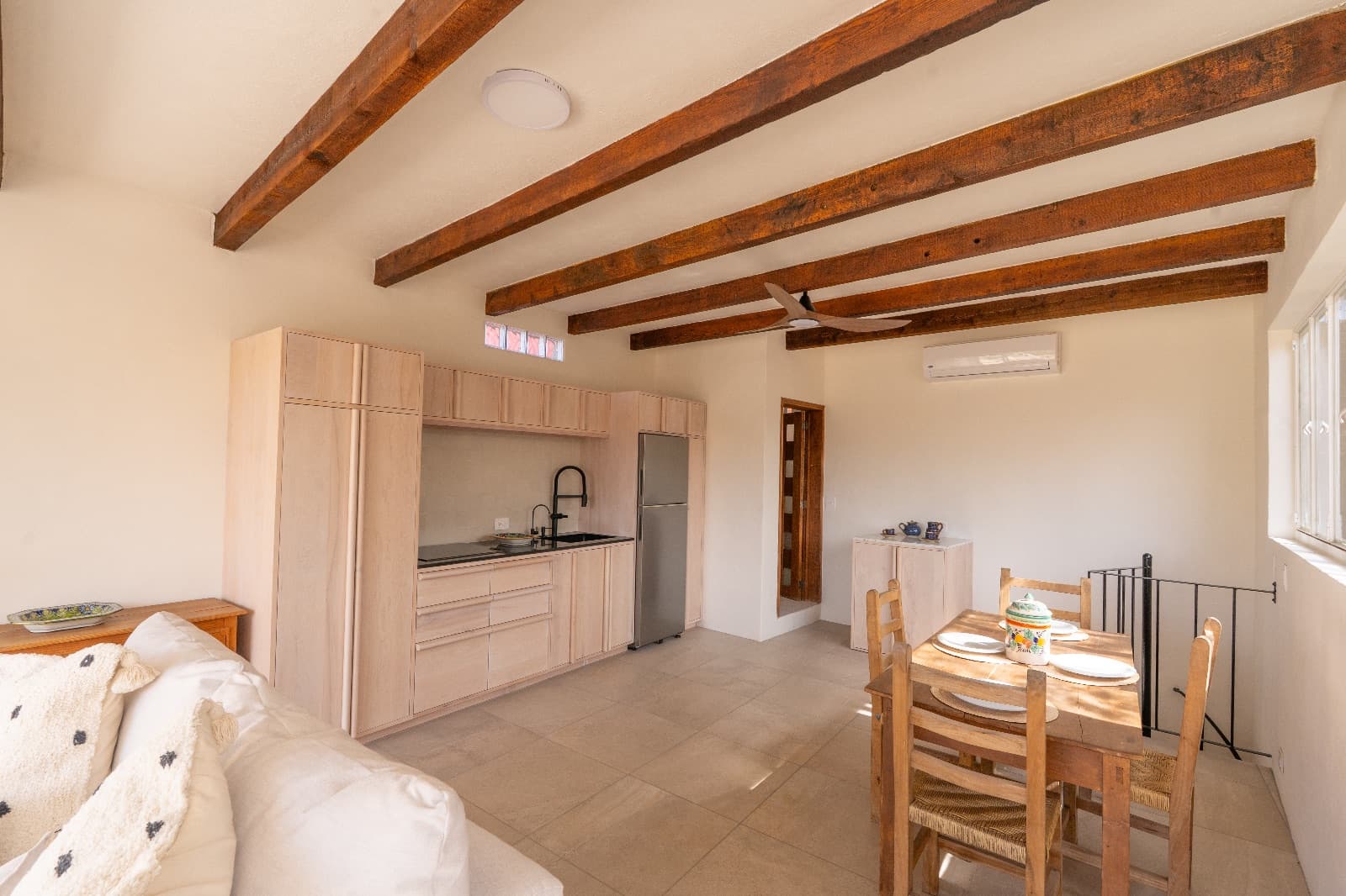 Condo del Sol — Guadalupe, San Miguel de Allende — photo 3 — rustic beams, light-filled open living