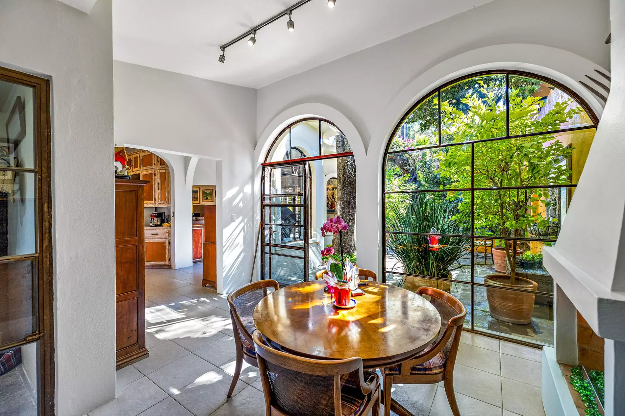 Casa Nispero — Atascadero (Arcos de San Miguel), San Miguel de Allende — photo 23 — sunlit dining room, arched windows, lush views