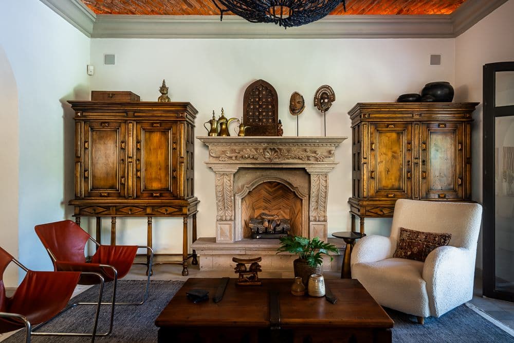 Casa Bella — Guadiana, San Miguel de Allende — photo 4 — elegant colonial fireplace, curated antiques