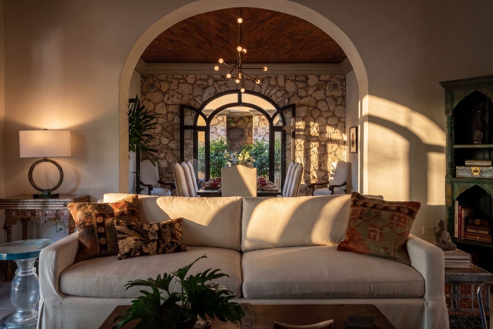 Casa Bella — Guadiana, San Miguel de Allende — photo 6 — golden sunlight bathes elegant archway living space