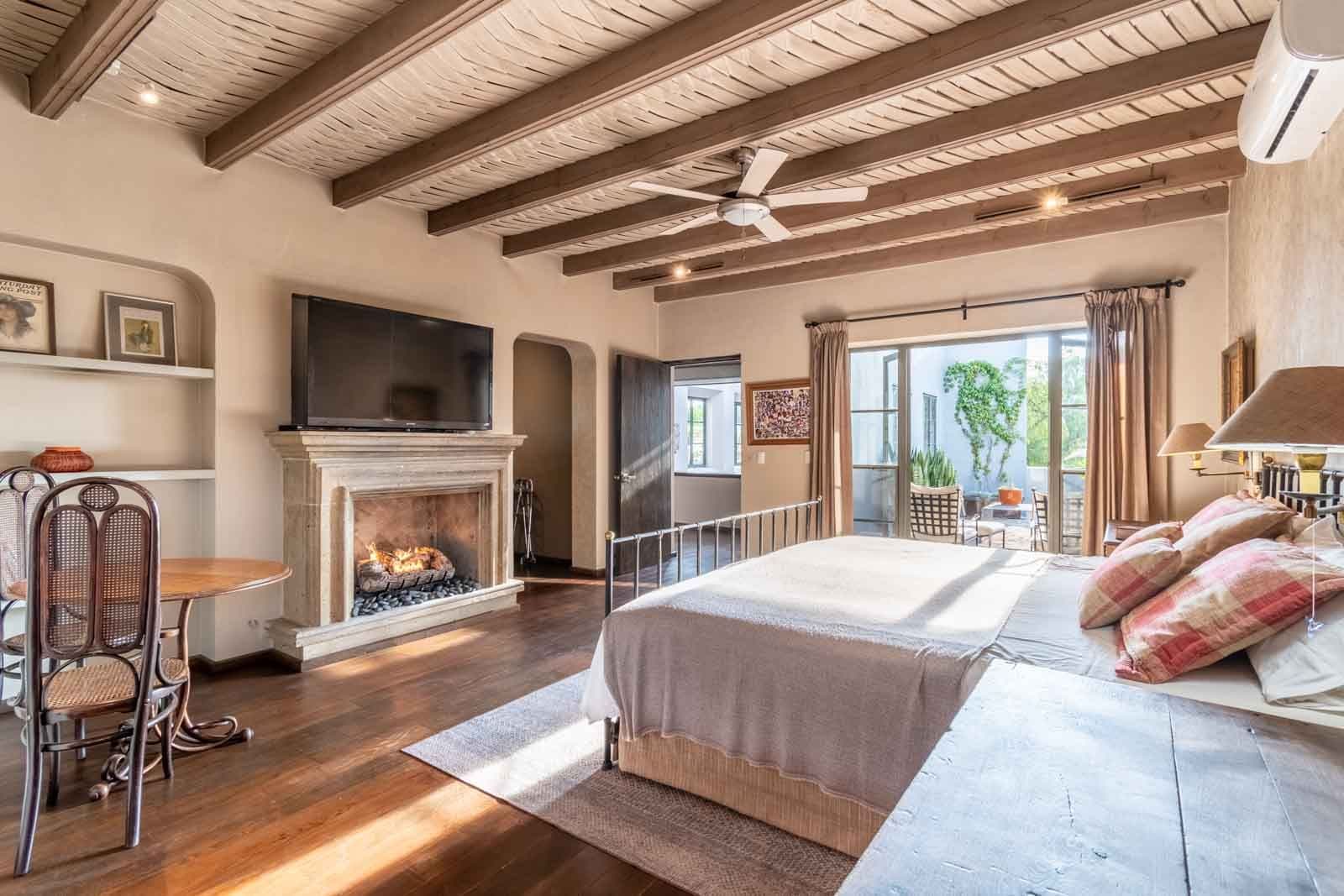 Villa Pirúl — Centro, San Miguel de Allende — photo 6 — rustic-elegant master suite with fireplace