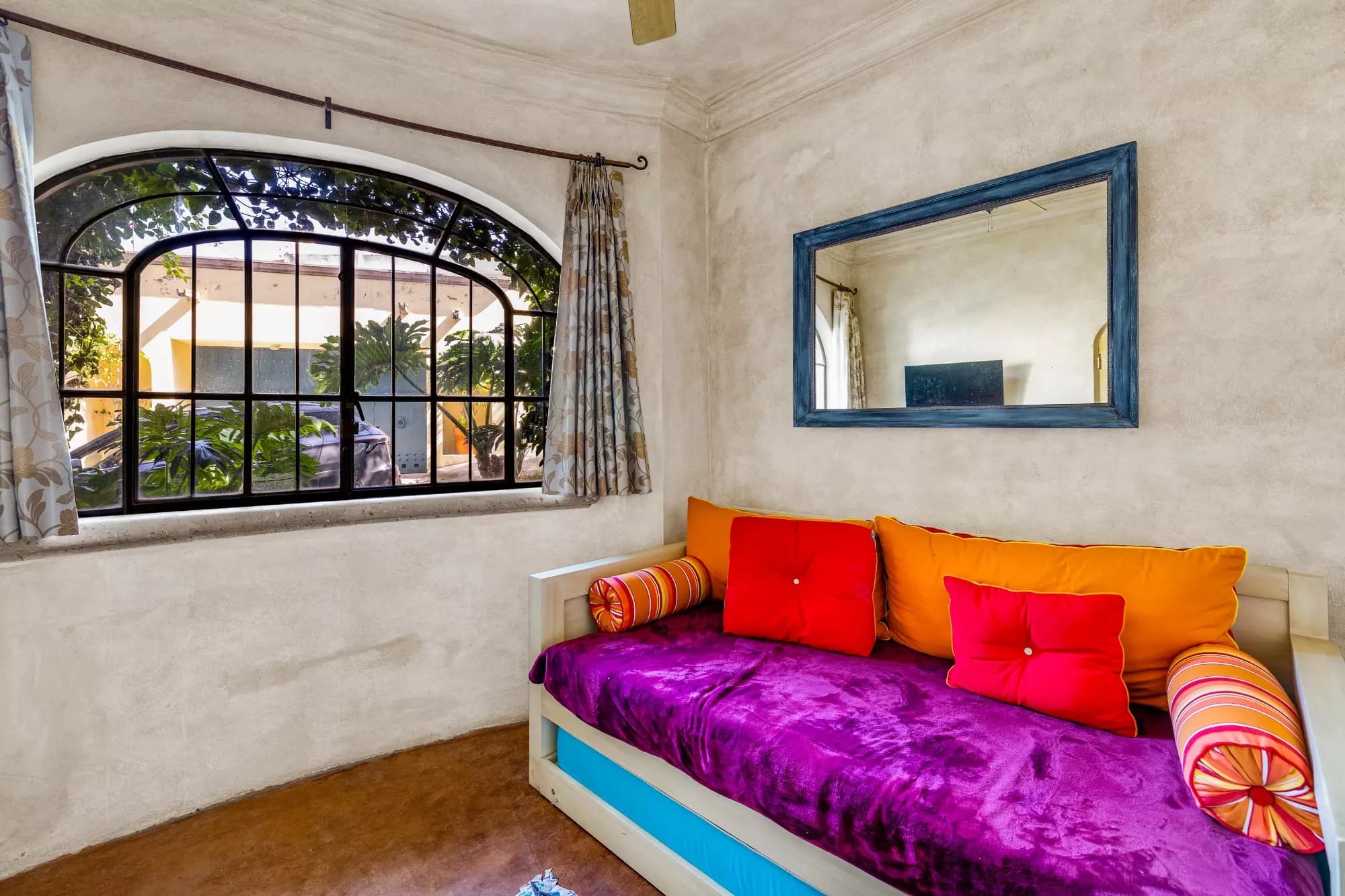 Casa Stone — Balcones, San Miguel de Allende — photo 3 — vibrant bedroom with arched garden views