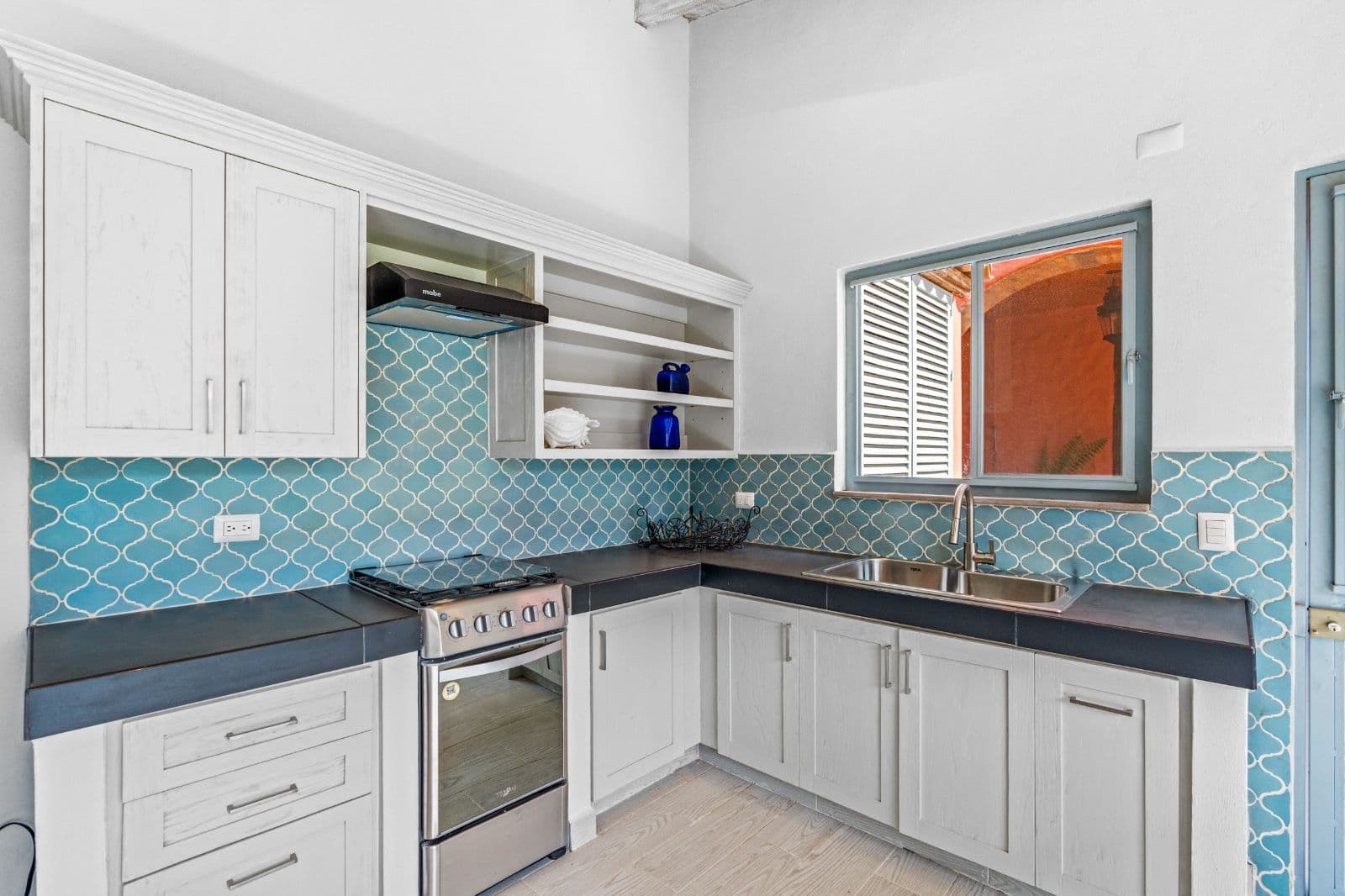 Casa Savia | A Private Garden Sanctuary in Los Frailes — Villa de los Frailes, San Miguel de Allende — photo 24 — contemporary kitchen with turquoise artisan tiles