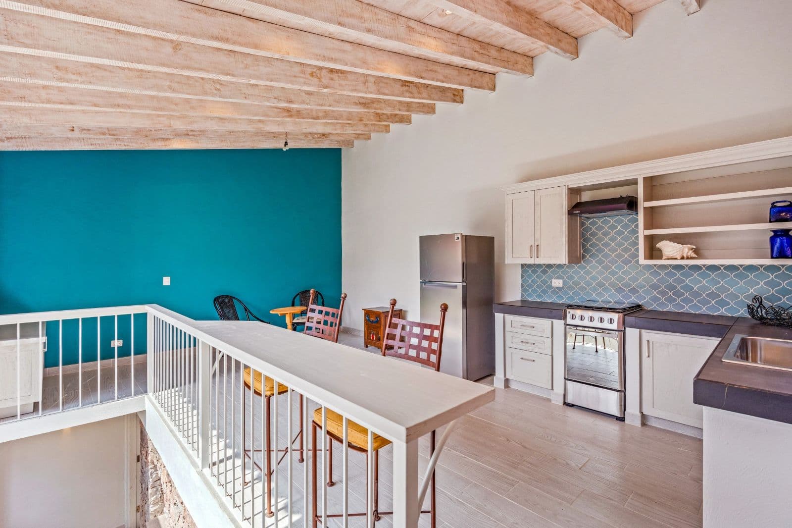 Casa Savia | A Private Garden Sanctuary in Los Frailes — Villa de los Frailes, San Miguel de Allende — photo 22 — bright open-concept kitchen with rustic beams