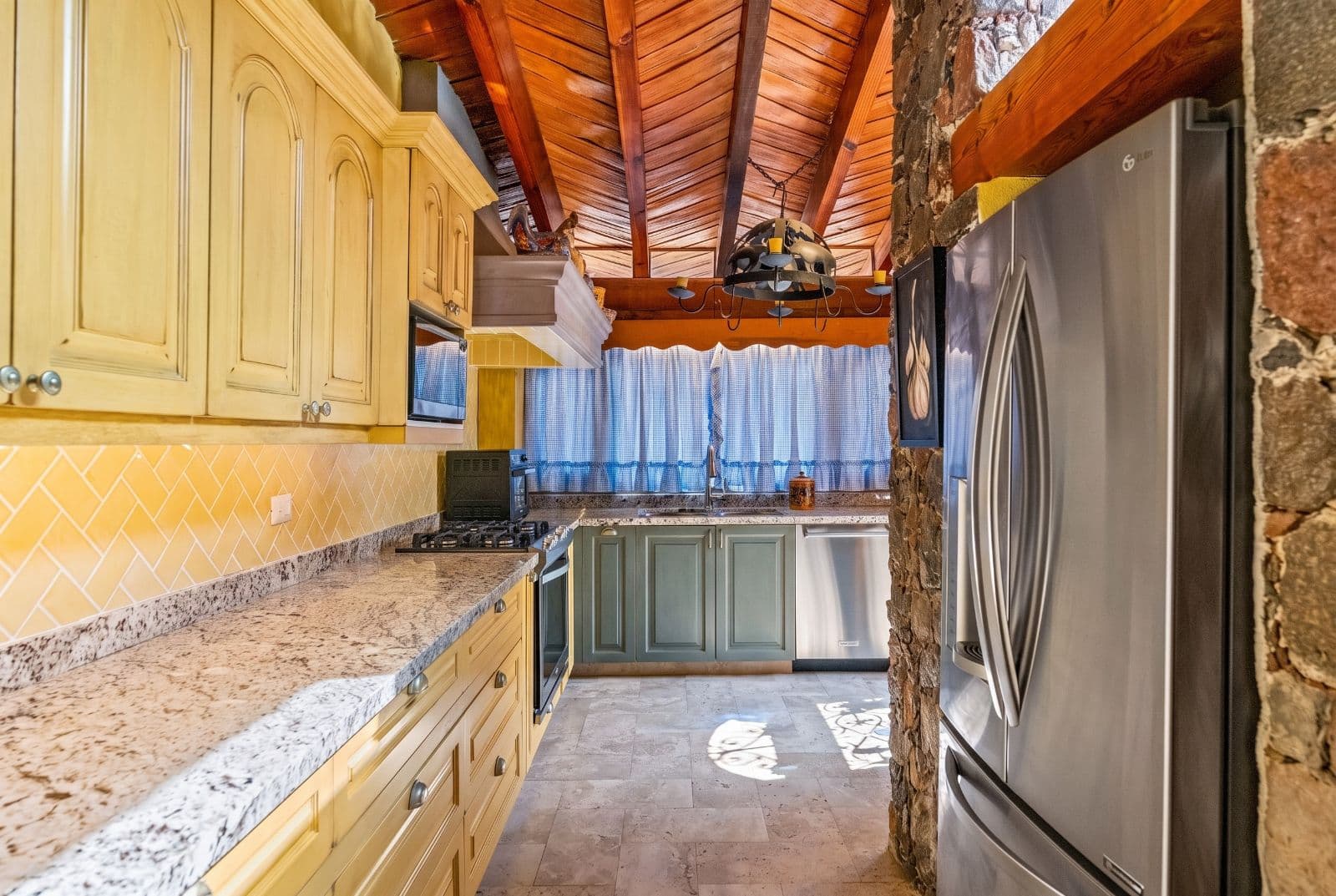 Casa Savia | A Private Garden Sanctuary in Los Frailes — Villa de los Frailes, San Miguel de Allende — photo 11 — rustic-elegant kitchen with soaring beams