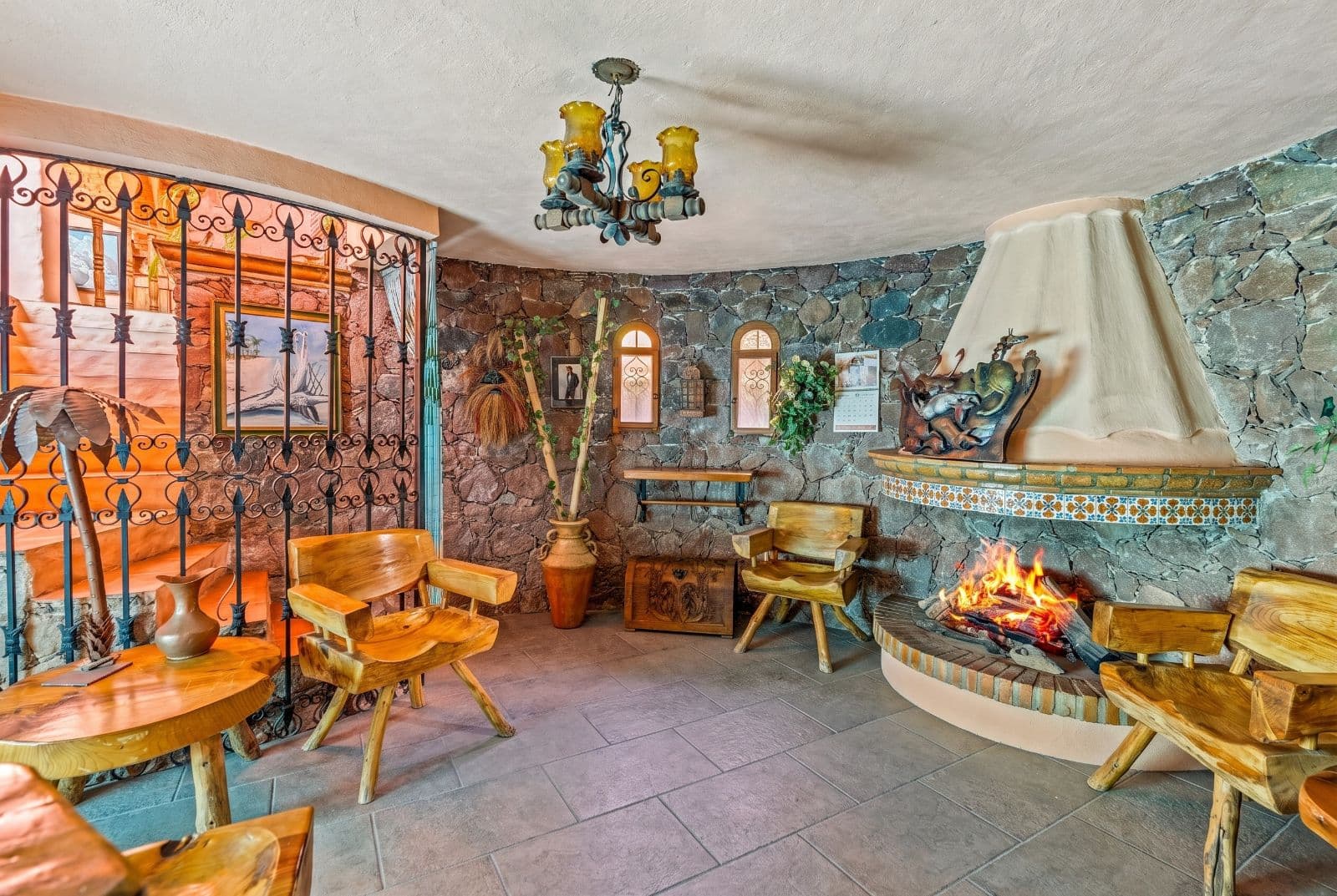 Casa Savia | A Private Garden Sanctuary in Los Frailes — Villa de los Frailes, San Miguel de Allende — photo 16 — rustic stone fireplace lounge retreat