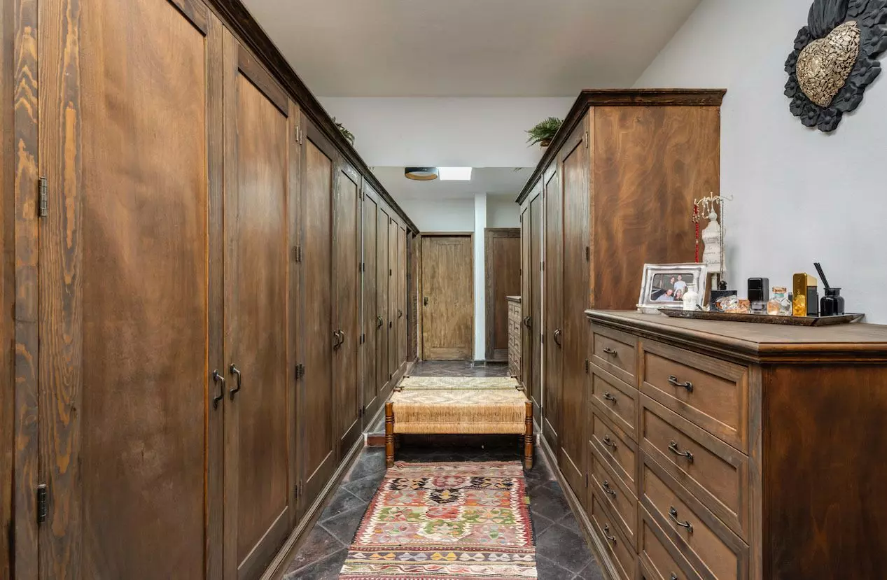 Casa Azul — Balcones, San Miguel de Allende — photo 7 — sophisticated walk-in closet with rich wood cabinetry